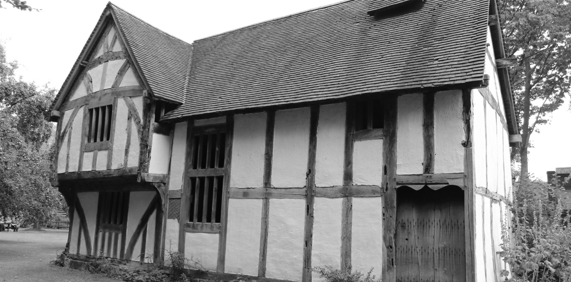 black and white image of family and their house