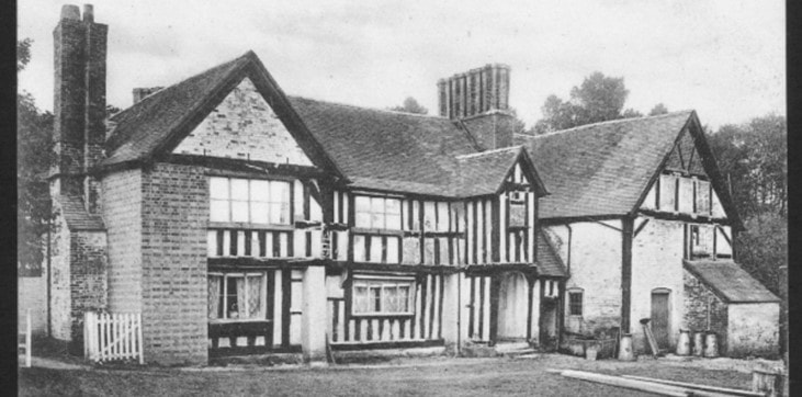 black and white image of a house and field